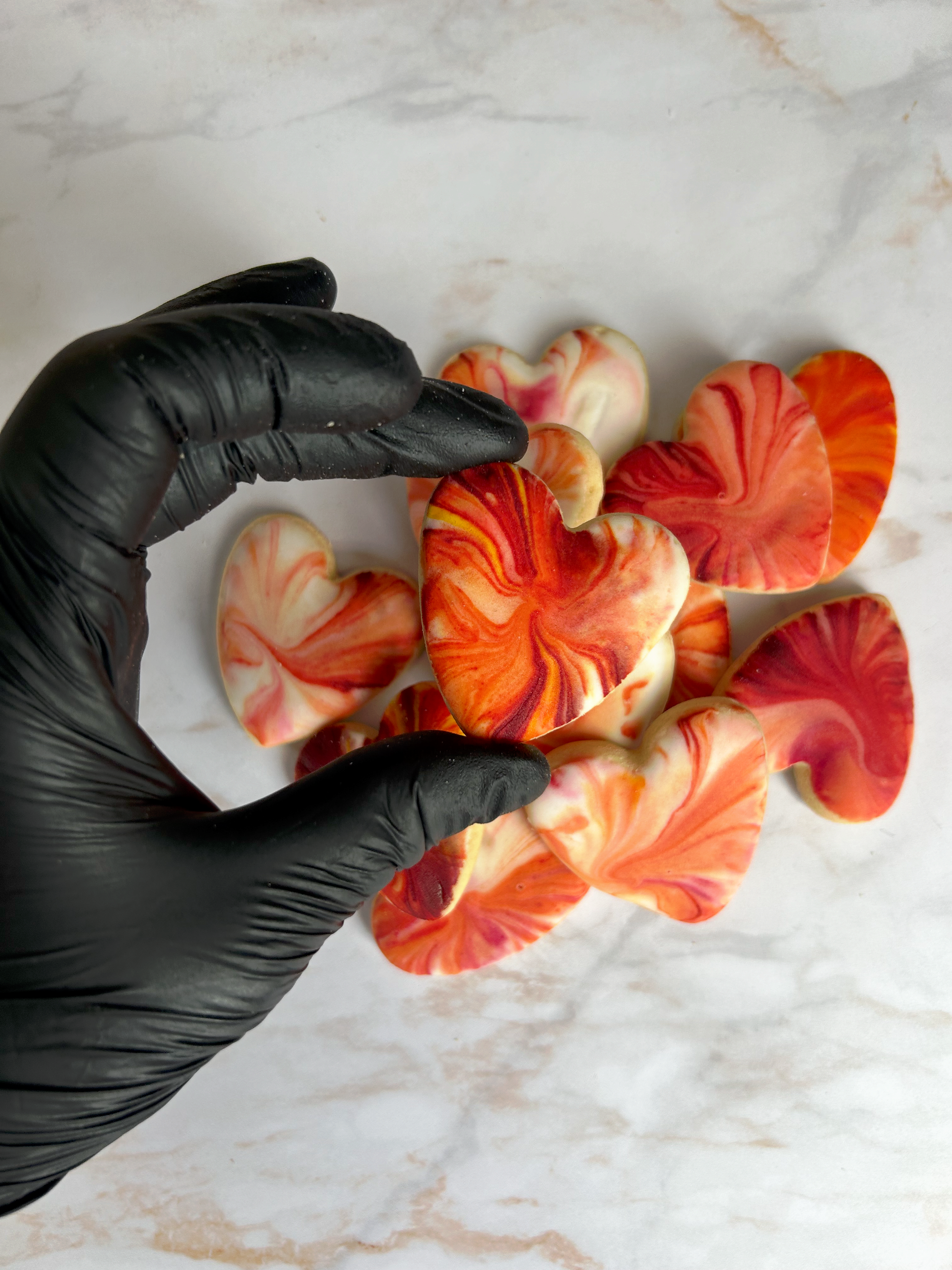 Biscuit cœur marbré rouge et ivoire au glaçage royal, décor artisanal.

Détail d’un biscuit sablé en forme de cœur, glaçage royal marbré.

Lot de biscuits cœurs décorés, création artisanale Les Folies Gourmandes de Judy.